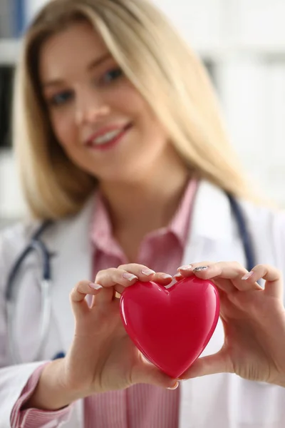 Cardiologist holds red heart in hands closeup —  Fotos de Stock
