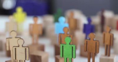 Multicolored figures of people in crowd closeup