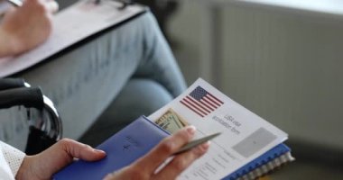 People fill out American visa application form by filling out paperwork