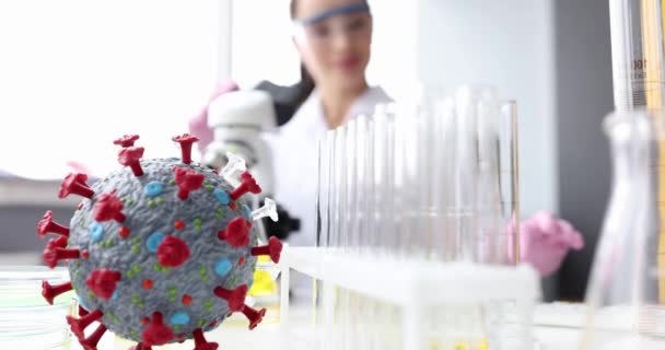 Scientist in laboratory studies bacteria and viruses in microscope. — Stockvideo