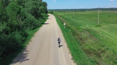 Active man on bicycle rides in nature nature