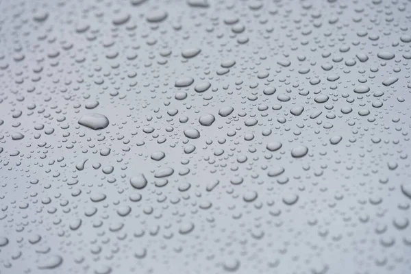 Small droplets of water on a matte gray background — Photo