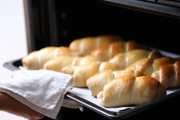 Open oven on a hot baking sheet, fresh baked goods — стоковое фото
