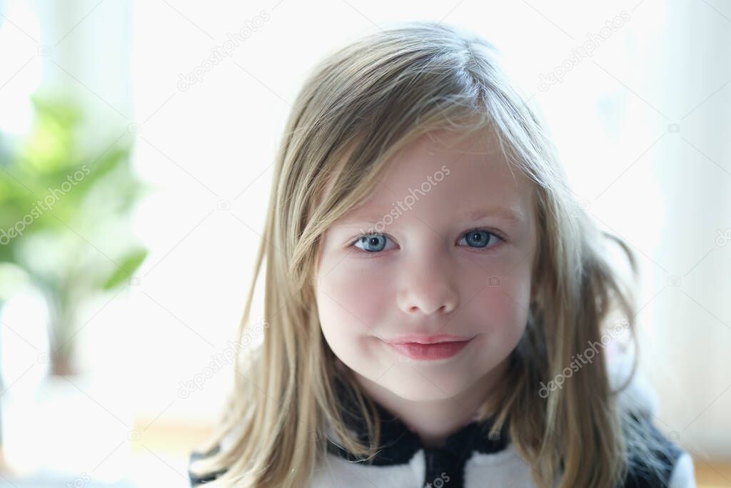 Portrait of a cute blonde girl, face close-up