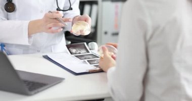 Doktor, klinikteki hastaya silikon göğüs implantı gösterdi.