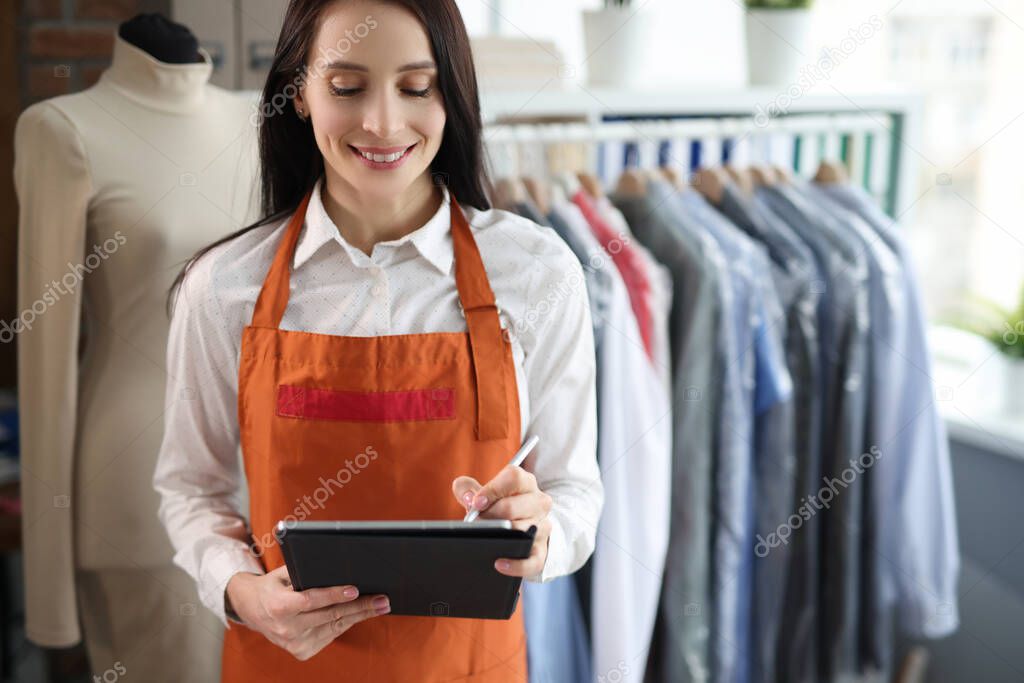 Dry cleaning administrator woman with tablet closeup