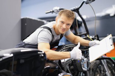Car maintenance service male show thumbs up and happily smile with clipboard clipart