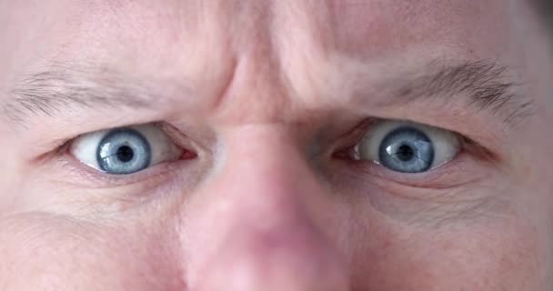 Vyděšený šokovaný vzhled muž s modrýma očima detailní up — Stock video