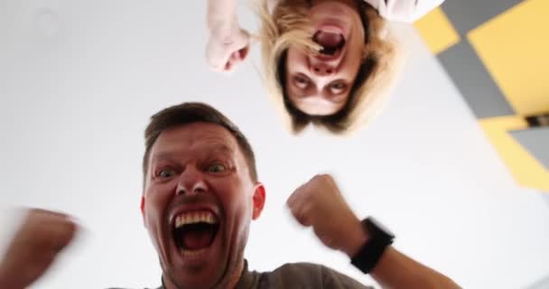 Man and woman unpacking box and rejoicing in pleasant surprise bottom view 4k movie — Vídeo de Stock