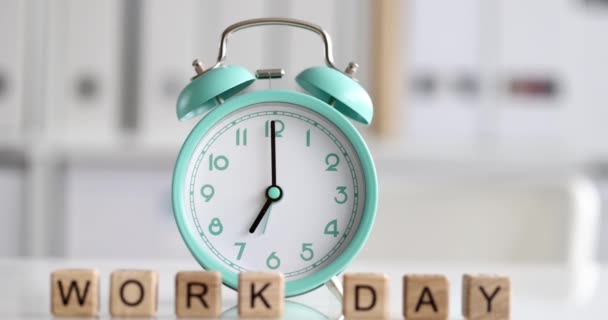 Relógio despertador para sete oclock e cubos com dia de trabalho de texto — Vídeo de Stock