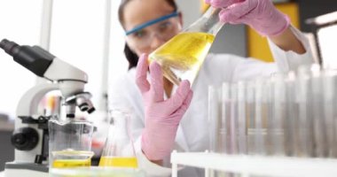 Kimyager test tüpünü kimyasal sıvı ve temizlik için yakıt ile tutuyor.