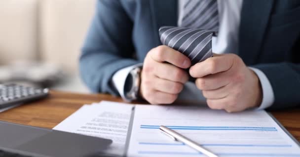 Businessman nervously touches tie at workplace closeup — Stock Video