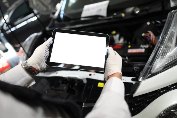 Mechanic worker using tablet for diagnostics of technical condition of vehicle — Stok fotoğraf