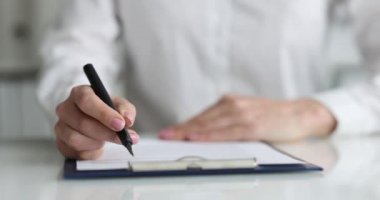 Businesswoman examines business contract and signs