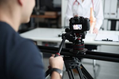 Female doctor recording vlog video about medicine and health care