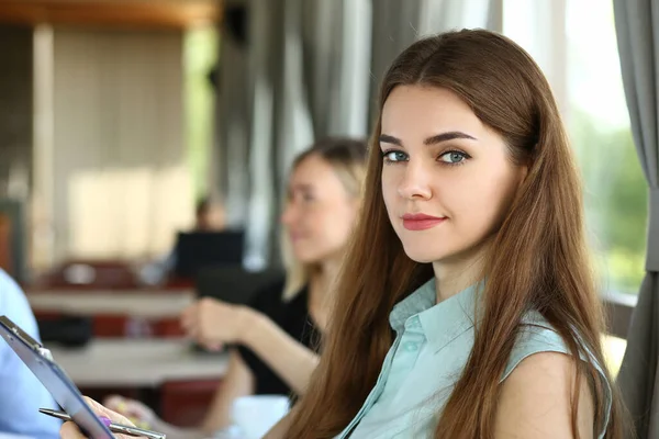 Cute young woman at business meeting in office — Fotografia de Stock