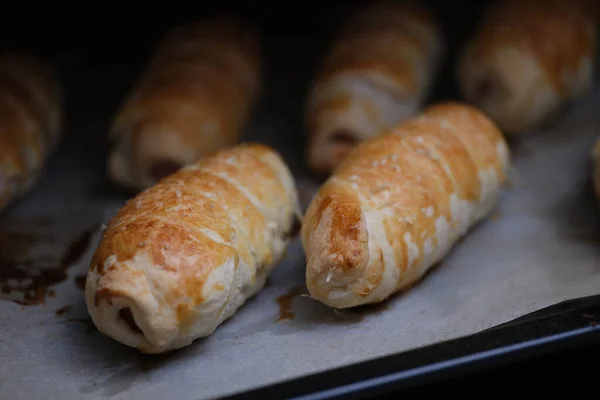 Homemade sausages in dough on baking sheet — Stok fotoğraf