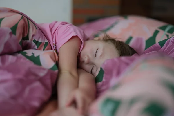 Lille pige barn sover sødt i sengen - Stock-foto