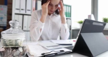 Upset businesswoman with headache at workplace
