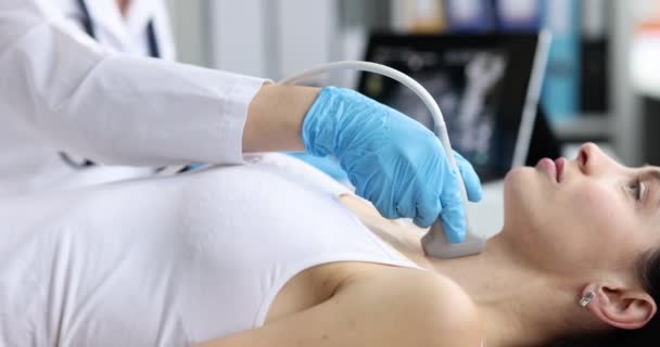 Doctor in diagnostic center makes ultrasound of thyroid gland — Video