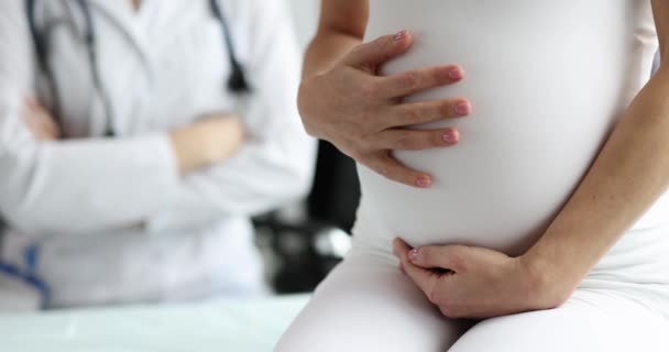 Donna incinta accarezza la pancia a appuntamento ginecologo. — Video Stock