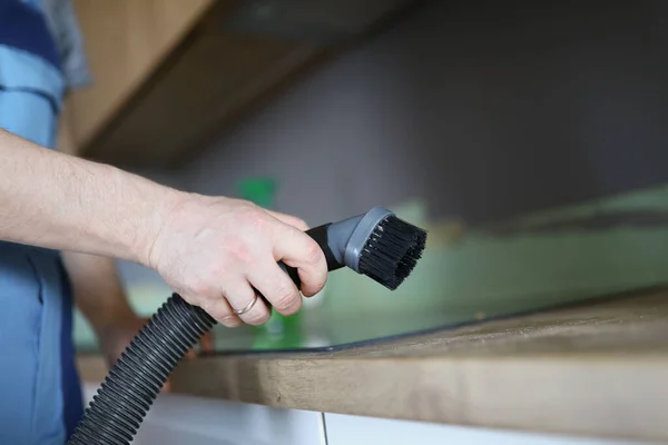 Male worker remove dust with vacuum cleaner, nozzle on cleaning device — Stock Photo, Image