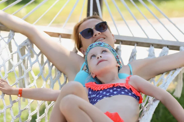 Mother and daughter lay on hammock in shade, enjoy life, time with family, mother daughter time — 스톡 사진