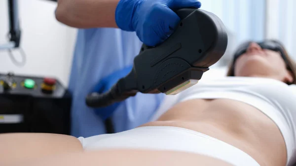 Cosmetologist removing unwanted hair from client body using laser closeup — Zdjęcie stockowe