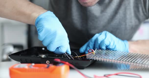 Engineer repairs electric lighting equipment and technical computer equipment — стоковое видео