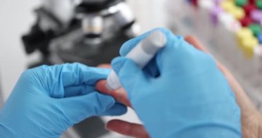 Doctor helps woman check her blood sugar levels with glucometer