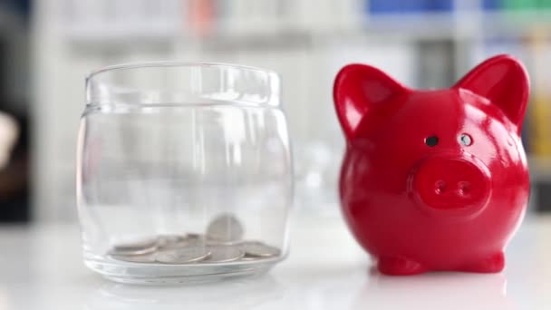 Replenishment of piggy bank with coins and piggy bank — Stock Video