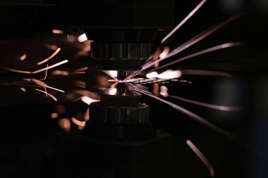 CNC laser cut metal in blue color with light spark