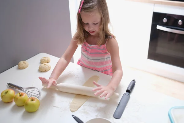 Child girl with rolling pin for baking cookies for dough — Fotografia de Stock