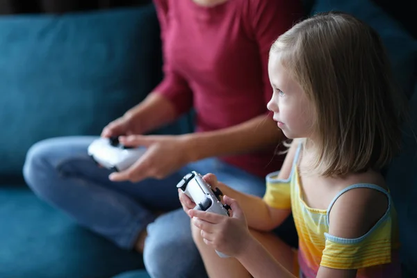 Mom daughter sitting on comfortable sofa and holding joystick — Foto Stock