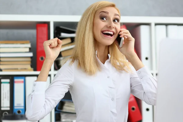 Happy worker got good news on phone, chatting during work time, excited to hear — Stockfoto