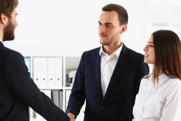 Couple shaking hands with realtor or lawyer, greet specialist in office — Foto de Stock