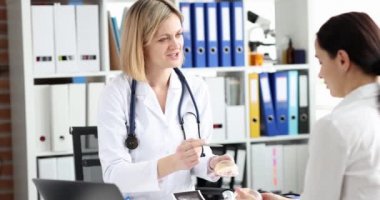 Doktor mamolog kadın göğüs implantı gösteriyor. 4K film ağır çekim.