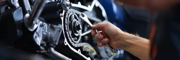 Master repairman repairing motorcycle with wrench closeup — Stock Photo, Image