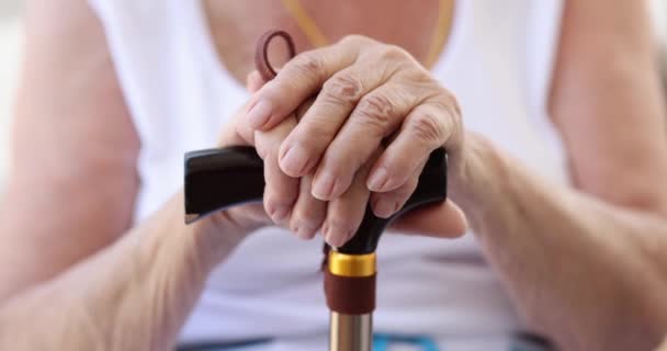 Sick elderly woman holding cane closeup 4k movie slow motion — Stock Video