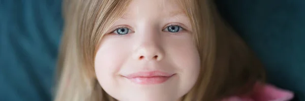 Χαμογελαστό πρόσωπο ενός μικρού χαριτωμένου κοριτσιού, κοντινό πλάνο — Φωτογραφία Αρχείου