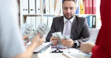 Başarılı iş adamlarından oluşan bir ekip ofiste nakit sayıyor. Finansal gelir ve karlı yatırım kavramı