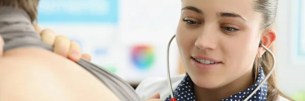 Portrait Young Female Doctor Listen Patients Back Stethoscope Equipment Concentrated — Stock Photo, Image