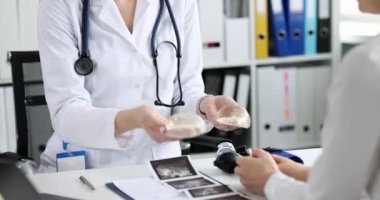 Doktor plastik cerrah silikon göğüs implantı yapar ve kadınlarla iletişim kurar. Göğüs büyütme ve kaldırma kavramı