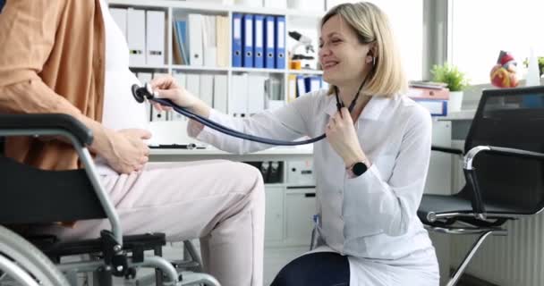 Doctor Listens Stethoscope Belly Pregnant Woman Wheelchair Clinic Heartbeat Child — Stock Video