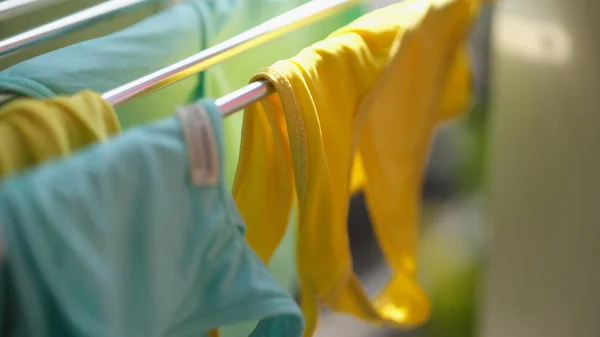 Clean washed clothes are dried in metal dryer closeup. Modes for washing clothes concept