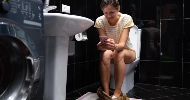 Woman Using Phone While Sitting Toilet Bathroom Home Smartphone Addiction — Stock Video