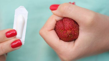 Woman hand holds medical candles for constipation and anatomy of anus. Hemorrhoids acute symptoms and treatment concept