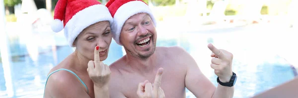 Man Woman Santa Claus Hats Show Fucking Gesture Monitor Remote — 图库照片
