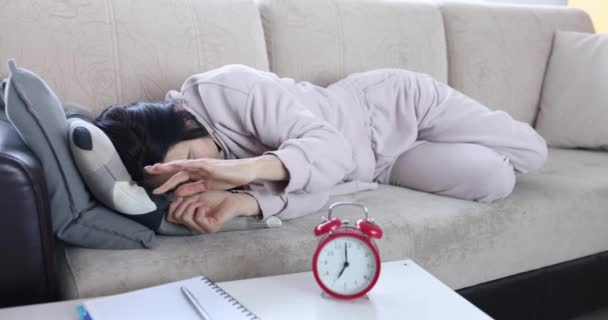 Woman Turns Alarm Clock Sleeps Couch Depression Chronic Fatigue Concept – Stock-video