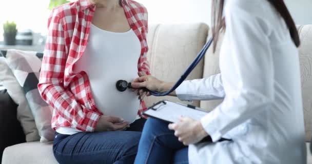 Dottore Ascolta Con Uno Stetoscopio Pancia Donna Incinta Casa Consultazione — Video Stock